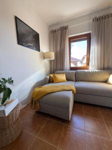 a living room with a couch and a window at Deer Hill in Orahovica