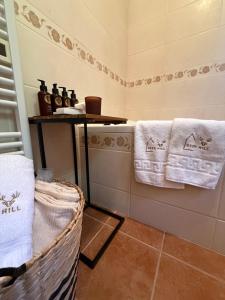 a bathroom with towels on a counter and a basket at Deer Hill in Orahovica +69 photos