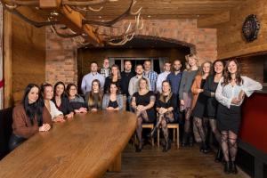 a group of people posing for a picture in a room at Arosa Vetter Hotel in Arosa