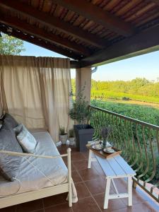 a bed and a table on a balcony with a view at Deer Hill in Orahovica