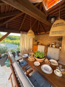 a dining room table with plates of food on it at Deer Hill in Orahovica