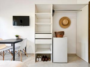 a bedroom with a white closet with a table and chairs at Hatton - 650m do plaży ! in Grzybowo