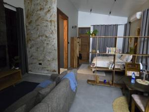 a living room with a couch and a bed at Verified Stone House in Dodoma