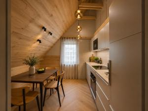 a kitchen and dining room with a table and chairs at Book-A-Room Salzburg Garden or Balcony Stay - 2 bedroom - air conditioning & free parking in Salzburg