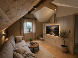 a living room with a couch and a table at Book-A-Room Salzburg Garden or Balcony Stay - 2 bedroom - air conditioning & free parking in Salzburg