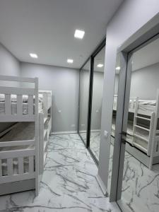 a bedroom with two bunk beds and a marble floor at Kaleju 10 Apartment in Tukums