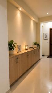 a lobby with a counter with plants on it at Halfway Home Cozy 2bhk in Rājpur