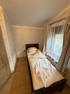 a small bed in a room with a window at Tadż Mahal Apartament in Sulechów +7 photos