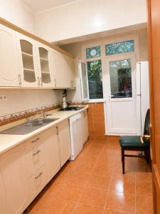 a kitchen with white cabinets and a sink and a window at Twin Double X2 Room in Istanbul