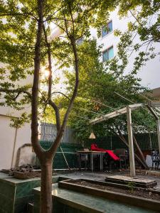 a patio with a tree and a picnic table at Twin Double X2 Room in Istanbul