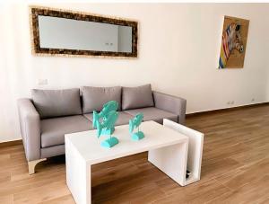 a living room with a couch and a table at Hotel Beach Pool Punta Cana Vacation in Punta Cana