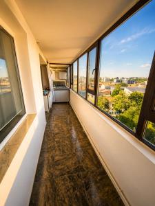 an empty hallway with large windows in a building at Central plaja Neversea in Constanţa +3 photos
