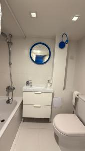 a bathroom with a sink and a toilet and a mirror at Cozy Loft Studio, one open space, in great location in Vilnius