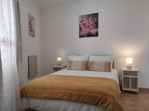 a bedroom with a large bed with two night stands at Casa Lotus in Aljezur