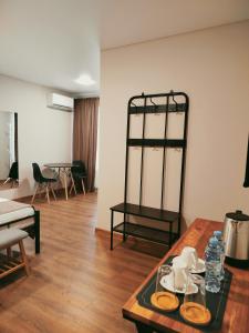 a living room with a table with dishes on it at Hotel Aura in Zugdidi