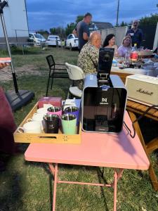 a table with a coffee maker on a pink table at Mega Life in Khashmi
