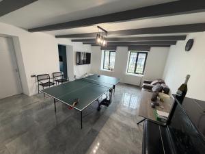 a room with a ping pong table and a bottle of wine at Mega Life in Khashmi