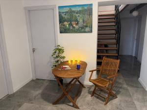 a room with a table and two chairs and a staircase at Mega Life in Khashmi
