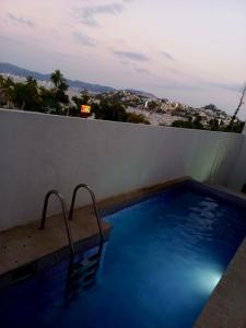 a swimming pool on the roof of a building at VILLA COSTERA HOTEL BOUTIQUE in Acapulco +43 photos