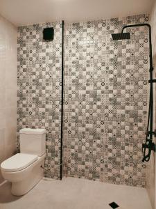 a bathroom with a toilet and a shower at Hotel Aura in Zugdidi
