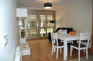 a living room with a white table and chairs at Apartamentos Cedeira in Cedeira