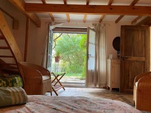 a bedroom with a door open to a garden at belles chambres d'hôte, spacieuses et paisibles, en pays de Forcalquier in Saint-Étienne-les-Orgues +46 photos
