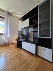 a living room with a tv and a large entertainment center at Piccola Stella in Moggio Udinese