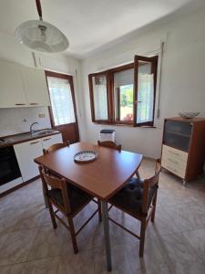 a kitchen with a wooden table and chairs in a room at Piccola Stella in Moggio Udinese +25 photos