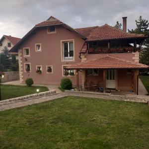 a house with a large yard in front of it at Apartmani Aleksijević Zlatibor in Zlatibor