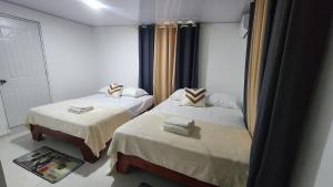 a room with two beds and a mirror at Boca de Yuma Adventure in Yuma