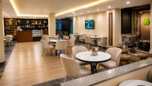 a restaurant with tables and chairs and a bar at Shitaye Suite Hotel in Addis Ababa