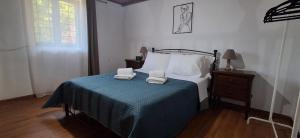 a bedroom with a bed with two towels on it at IRENE'S village home in Loutrákion