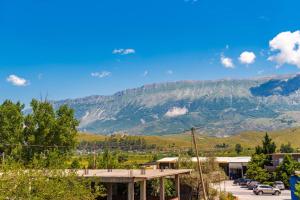 a view of a mountain with cars parked in a parking lot at Bliss by PikHost in Gjirokastër