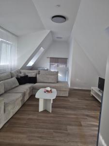 a living room with a couch and a table at Nektarios Bulus in Kernen