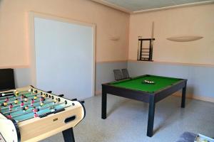 a room with a foos ball and a table at L'Ecrin du Chalet d'Arguel in Pugey