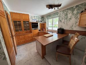 a kitchen with a table and a chair in it at Ferienwohnung Brandmaier in Unken +11 photos