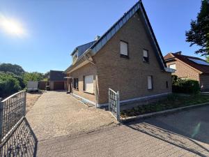 a brick house with a fence in front of it at Cosy Place Xanten in Xanten