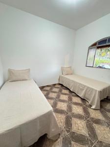 a room with two beds and a window at Sítio do Miguel in Barbacena +38 photos
