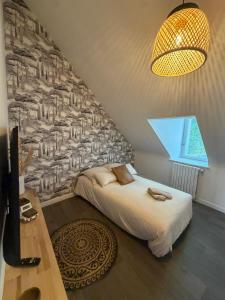 a bedroom with a bed and a wall mural at La Cabane Perchée in Saint-Brieuc +5 photos