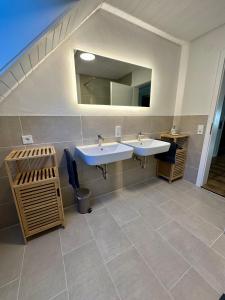 a bathroom with two sinks and a mirror at FeWo Ruf in Sasbach am Kaiserstuhl +13 photos