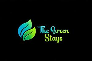 a green logo with the green stays on a black background at The Green stays in Madurai
