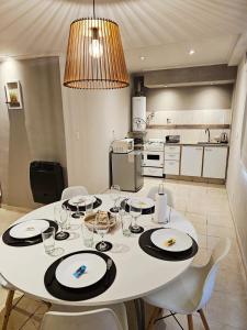 a dining room with a white table and chairs at departamento Malbec cosecha 17 in Ciudad Lujan de Cuyo