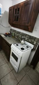 a kitchen with a stove and a counter top at El ROBLE 2 in Córdoba