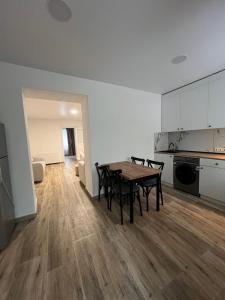 a kitchen and dining room with a table and chairs at Casa Bianca Kobuleti in Kobuleti