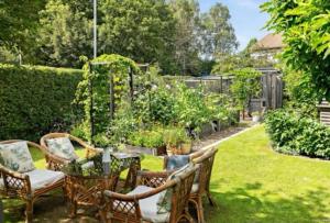a garden with chairs and a table in the grass at Villa in Gothenburg in Gothenburg