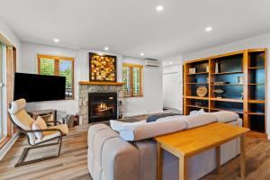 a living room with a couch and a fireplace at Hauts-bois Ski Inout 2brs Wpool Access 193-1 in Mont-Tremblant