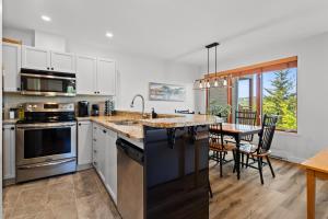 a kitchen with a counter top and a dining room at Hauts-bois Ski Inout 2brs Wpool Access 193-1 in Mont-Tremblant