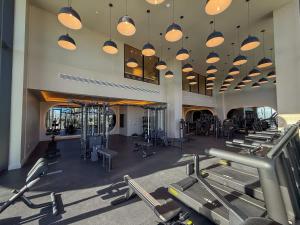 a gym with many rows of treadmills and machines at Luxury View-Walk to beach! in Miami Beach