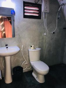 a bathroom with a toilet and a sink at Sambu Cabana Panama in Panama +50 photos