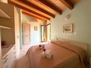 a bedroom with a bed with towels on it at Villa Flavia with pool and private parking in Costa Paradiso